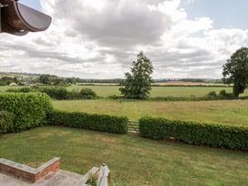 A view of a field with trees and hedges at Filly Brook in Bishop's Frome