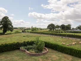 A view of a field with sheep and trees at Filly Brook in Bishop's Frome