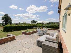 A patio with a table and chairs at Filly Brook in Bishop's Frome