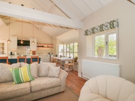 A living room and kitchen area with seating and a dining table at Cleveley Mill in Enstone
