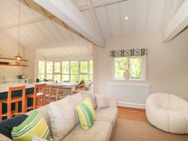 A living room with a sofa and dining area at Cleveley Mill in Enstone