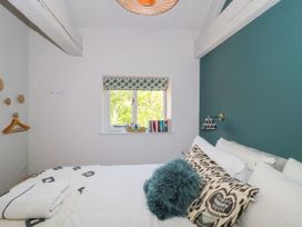 A bedroom with a bed and a window at Cleveley Mill in Enstone