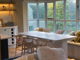 A dining room with a table and chairs at The Annexe, Cleveley Mill Chipping Norton