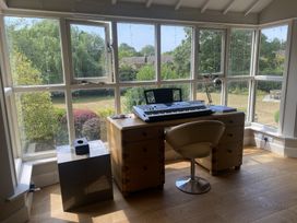 A study with a desk and keyboard at The Annexe, Cleveley Mill, Enstone