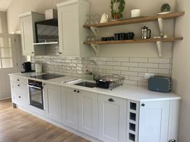 A kitchen with cabinets and appliances at The Annexe, Cleveley Mill Enstone