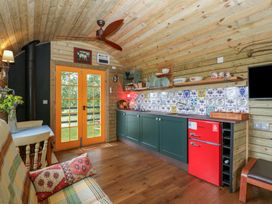 A kitchen with a red fridge and cabinets at Shepherd Hut’s in Bristol