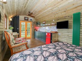 A studio with a bed and kitchen area at Shepherd Hut’s Bristol