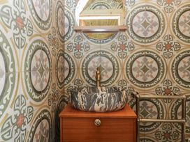 A bathroom with a sink and mirror at Shepherd Hut’s in Bristol