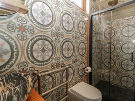 A bathroom with a toilet and shower at Shepherd Hut’s Bristol