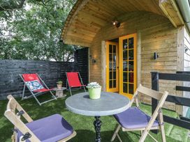 An outdoor seating area with chairs and a table at Shepherd Hut’s in Bristol