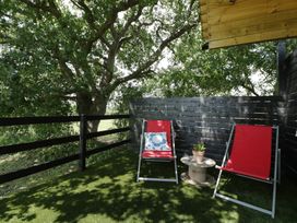 An outdoor space with two chairs and a table in Shepherd Hut’s, Bristol