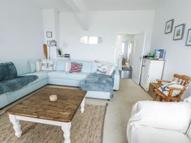 A living room with a sofa and coffee table at Lady of the Lake Suite Trearddur Bay
