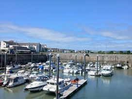 A marina with boats and buildings at Pines 15 in Porthcawl