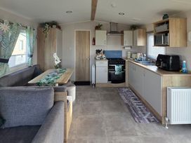 A kitchen with seating area at Pines 15 in Porthcawl
