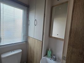 A bathroom with a sink and a toilet at Pines 15 in Porthcawl