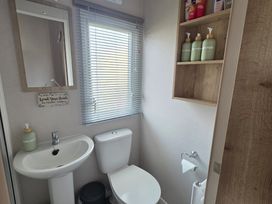 A bathroom with a sink and toilet at Pines 15 in Porthcawl