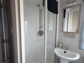 A bathroom with a shower and a sink at Pines 15 in Porthcawl