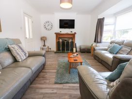 A living room with sofas and a fireplace at Seabreeze in Llandudno