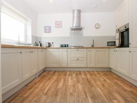 A kitchen with a sink and stove at Seabreeze in Llandudno