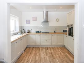 A kitchen with cabinets and appliances at Seabreeze in Llandudno