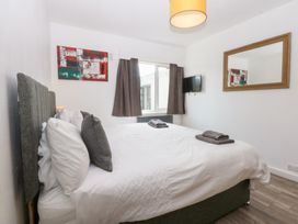 A bedroom with a bed and television at Seabreeze, Llandudno