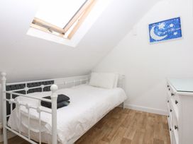 A bedroom with a single bed and a dresser at Seabreeze in Llandudno