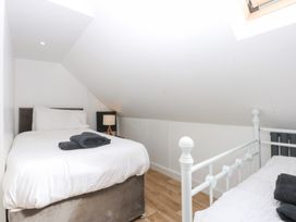 A bedroom with two beds and a lamp at Seabreeze in Llandudno