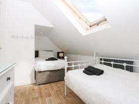 A bedroom with two beds and a skylight at Seabreeze in Llandudno