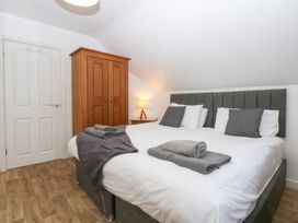 A bedroom with a bed and wardrobe at Seabreeze in Llandudno
