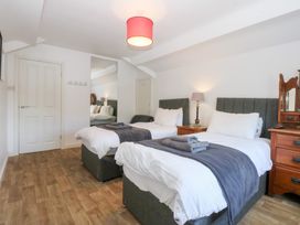 A bedroom with two beds and a dresser at Seabreeze in Llandudno