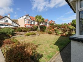 An outdoor view of a garden and houses at Seabreeze in Llandudno