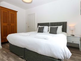 A bedroom with a double bed and wardrobe at Seabreeze in Llandudno