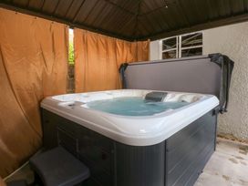 A hot tub with cover in an outdoor space at Seabreeze, Llandudno
