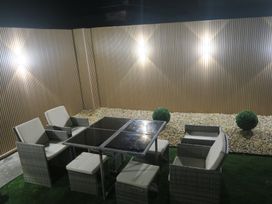 An outdoor seating area with a table and chairs at Seabreeze in Llandudno