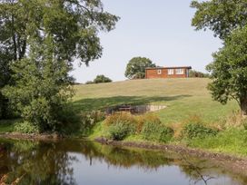 A house on a hill overlooking water at Twilight in Raglan