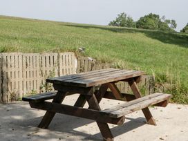 A picnic table on grass at Twilight in Raglan