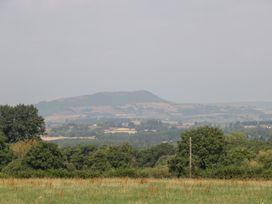 A landscape view featuring a mountain and trees at Twilight in Raglan