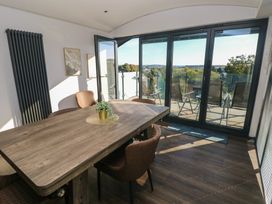A dining room with a table and chairs at 10 Brython Place in Tenby