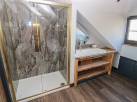 A bathroom with a shower and sink at 10 Brython Place Tenby