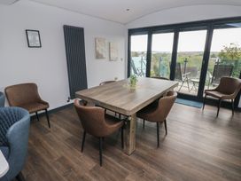 A dining room with a table and chairs at 10 Brython Place Tackley
