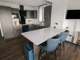 A kitchen featuring appliances and seating at 10 Brython Place Tackley