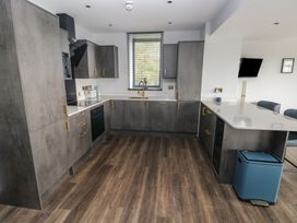 A kitchen with cabinets and appliances at 10 Brython Place Tackley