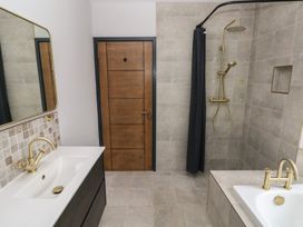 A bathroom with a sink and shower at 10 Brython Place in Tackley