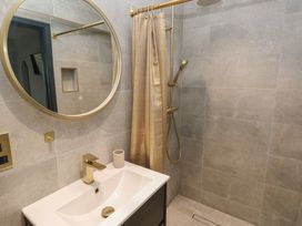 A bathroom with a shower and sink at 10 Brython Place in Tackley