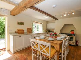 A kitchen with a dining table and chairs at Keepers Cottage in Devizes