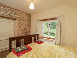 A bedroom with a bed and towels on top at Keepers Cottage in Devizes