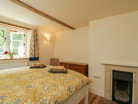 A bedroom with a bed and a window at Keepers Cottage in Devizes
