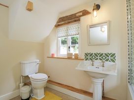 A bathroom with a toilet and sink at Keepers Cottage in Devizes