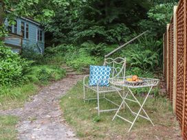An outdoor seating area with a chair and table at The Boat House in Ashprington