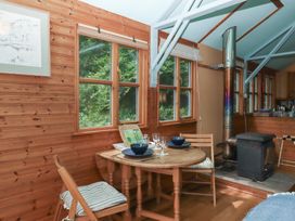 A dining area with a table and chairs at The Boat House in Ashprington